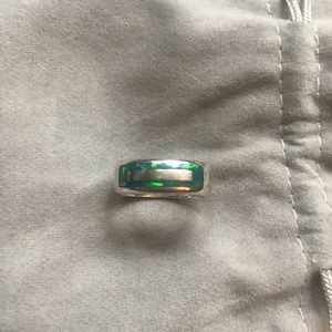 Beautiful silver band ring with embedded gems.